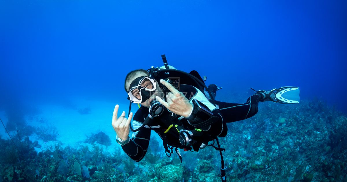 A scuba-diver exploring the Belize Blue Hole, posing for an underwater picture.