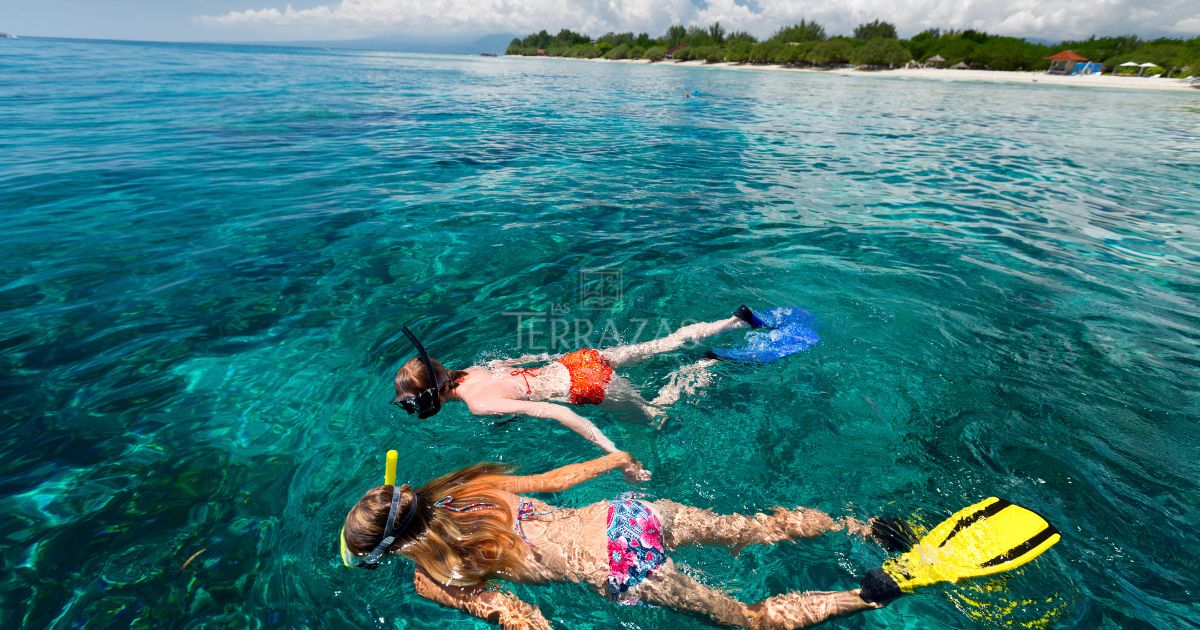 Siblings snorkeling near our resort - surrounded by the emerald water.