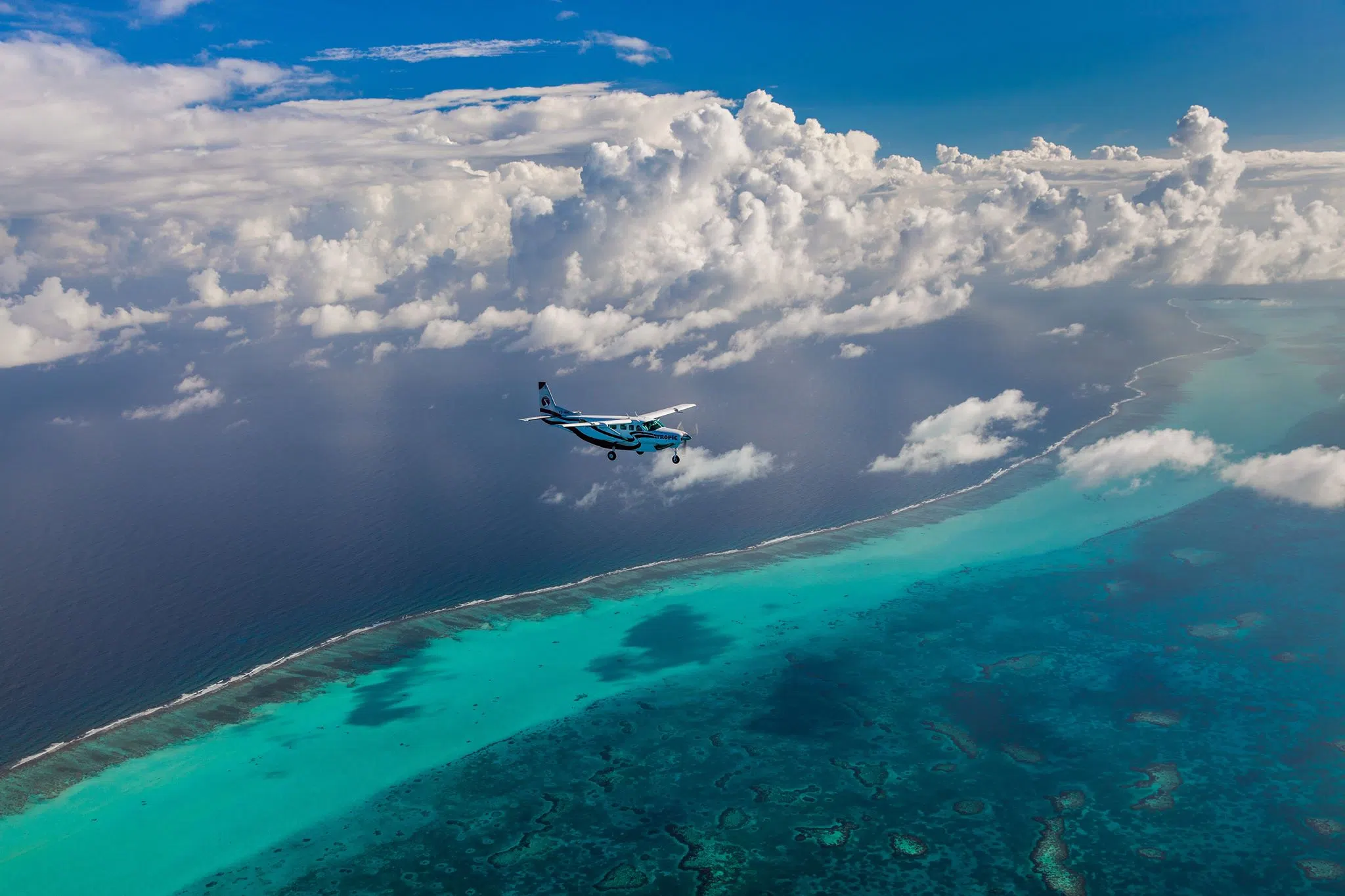 Aerial view of turquoise Caribbean water and reef around Ambergris Caye, Belize